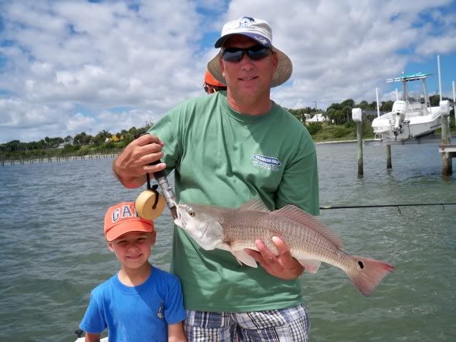 father and son with redfish